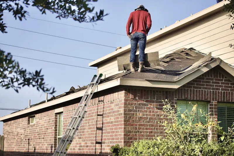 Professional roofer working on a residential roof in St. Rose